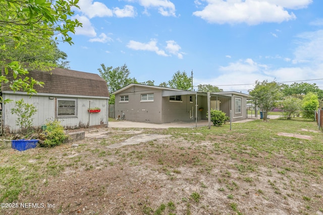 7314 Hielo Dr, Jacksonville, FL 32211 - rear view of house with an outbuilding and a patio