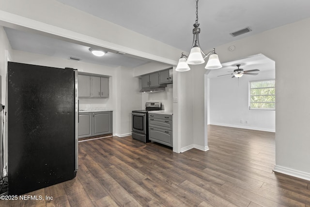 7314 Hielo Dr, Jacksonville, FL 32211 - kitchen with gray cabinetry, electric stove, freestanding refrigerator, under cabinet range hood, and dark wood-style flooring