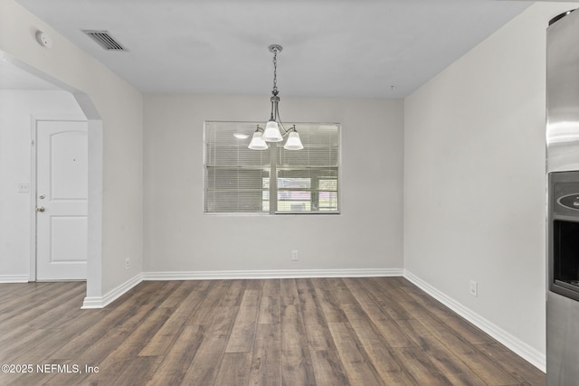7314 Hielo Dr, Jacksonville, FL 32211 - unfurnished dining area featuring wood finished floors, a chandelier, and arched walkways