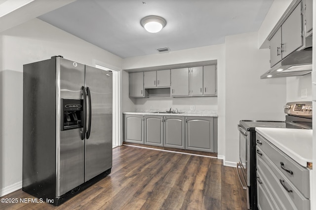 7314 Hielo Dr, Jacksonville, FL 32211 - kitchen featuring appliances with stainless steel finishes, gray cabinetry, under cabinet range hood, and dark wood-style floors