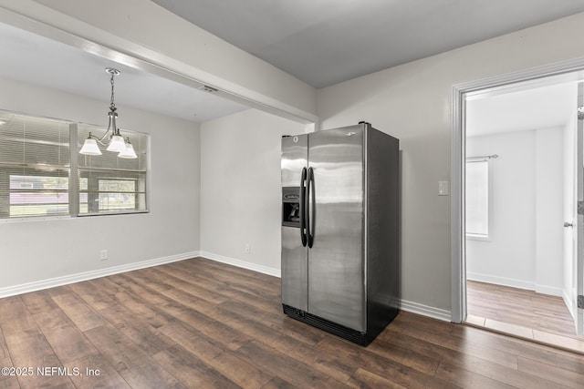 7314 Hielo Dr, Jacksonville, FL 32211 - kitchen with stainless steel fridge with ice dispenser, dark wood finished floors, and pendant lighting
