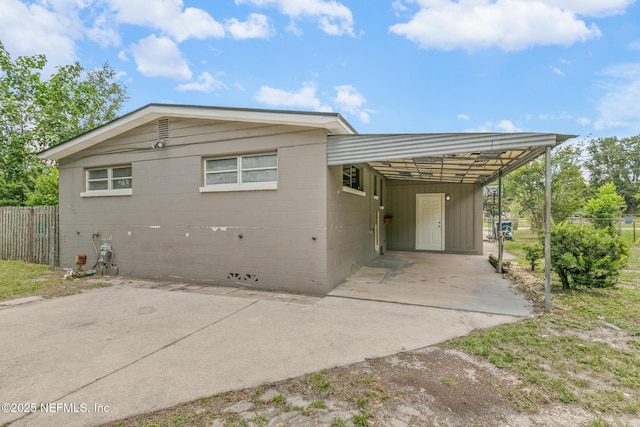 7314 Hielo Dr, Jacksonville, FL 32211 - view of front of house featuring concrete driveway, a carport, and concrete block siding