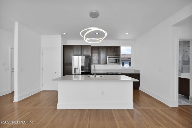 2525 College St Unit 1305, Jacksonville, FL 32204 - kitchen with appliances with stainless steel finishes, light countertops, dark brown cabinets, light wood-type flooring, and recessed lighting