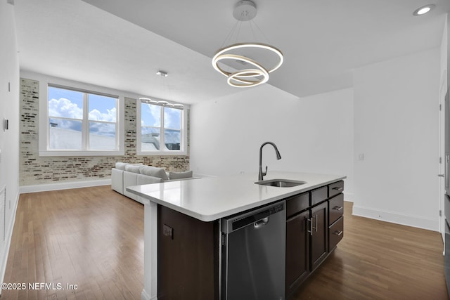2525 College St Unit 1305, Jacksonville, FL 32204 - kitchen featuring dishwasher, light countertops, wood finished floors, a center island with sink, and dark brown cabinetry