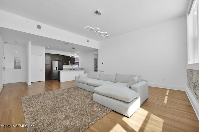 2525 College St Unit 1305, Jacksonville, FL 32204 - living area with light wood-style floors and electric panel