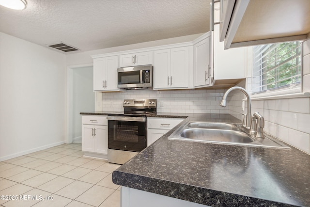 423 S Blvd, Macclenny, FL 32063 - kitchen with stainless steel appliances, dark countertops, backsplash, and a textured ceiling