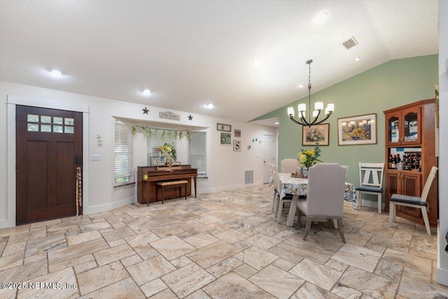 3776 Arrowhead Dr, Saint Augustine, FL 32086 - dining area with stone tile flooring, a chandelier, vaulted ceiling, and recessed lighting