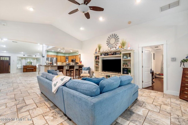 3776 Arrowhead Dr, Saint Augustine, FL 32086 - living room featuring ceiling fan, stone tile flooring, and high vaulted ceiling