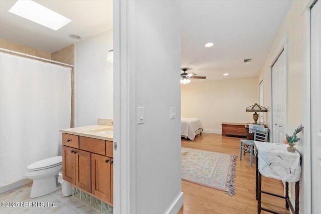 3776 Arrowhead Dr, Saint Augustine, FL 32086 - full bath featuring ensuite bath, vanity, wood finished floors, a ceiling fan, and a skylight