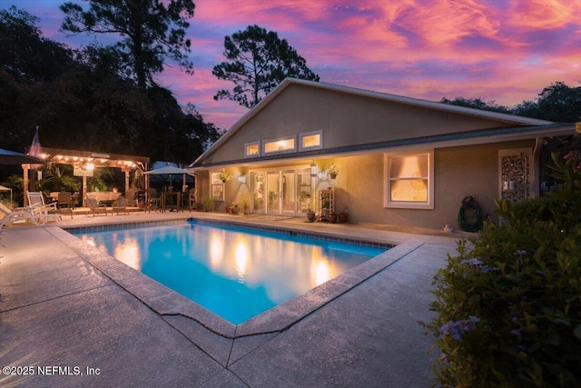 3776 Arrowhead Dr, Saint Augustine, FL 32086 - pool at dusk featuring a patio area and an outdoor pool