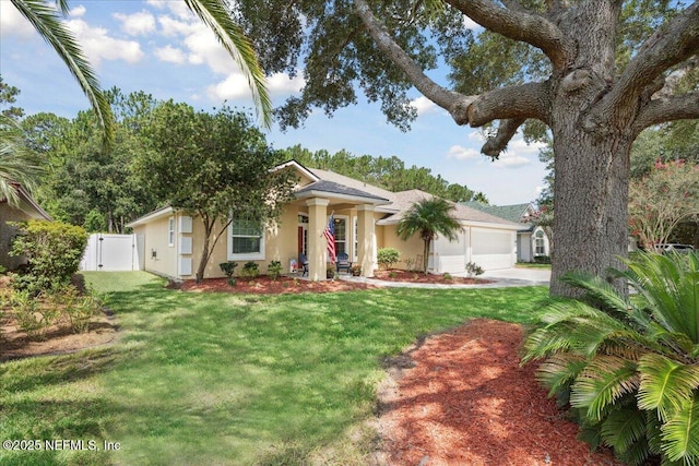 573 N Bridgestone Ave, Saint Johns, FL 32259 - view of front of house with an attached garage, a gate, concrete driveway, and stucco siding
