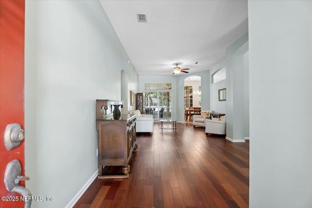 573 N Bridgestone Ave, Saint Johns, FL 32259 - corridor with arched walkways, dark wood finished floors, and a textured ceiling