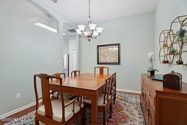573 N Bridgestone Ave, Saint Johns, FL 32259 - dining area featuring a chandelier, dark wood-style floors, and arched walkways