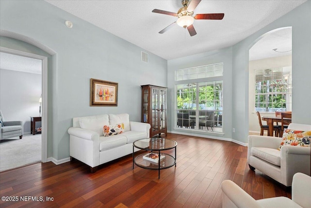 573 N Bridgestone Ave, Saint Johns, FL 32259 - living room with ceiling fan, arched walkways, and dark wood-type flooring