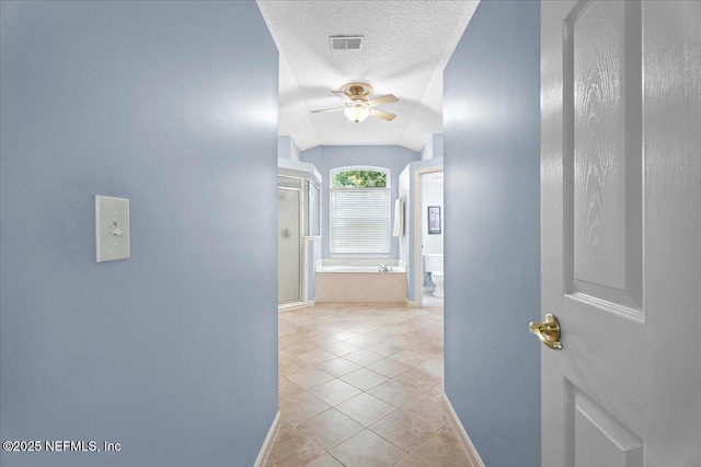 573 N Bridgestone Ave, Saint Johns, FL 32259 - hallway featuring light tile patterned floors and a textured ceiling