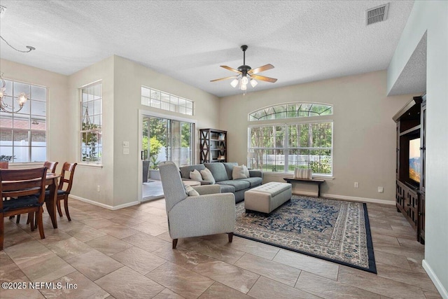 573 N Bridgestone Ave, Saint Johns, FL 32259 - living room featuring a textured ceiling, ceiling fan, and a chandelier