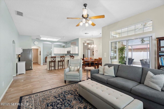 573 N Bridgestone Ave, Saint Johns, FL 32259 - living area with arched walkways, ceiling fan, a textured ceiling, and a chandelier