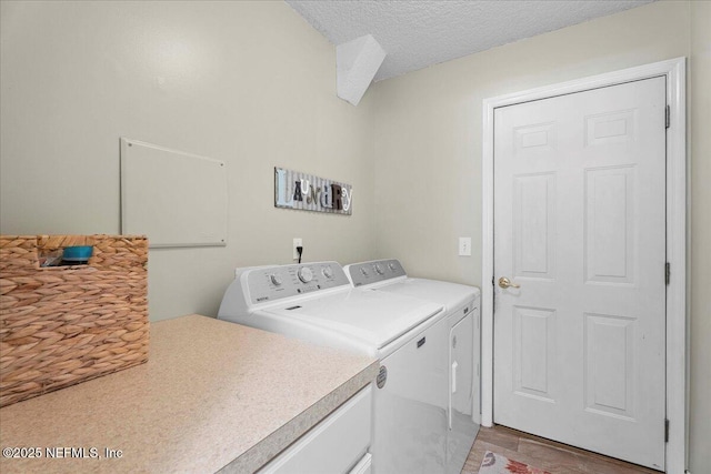 573 N Bridgestone Ave, Saint Johns, FL 32259 - laundry area featuring separate washer and dryer, a textured ceiling, and light wood-style flooring