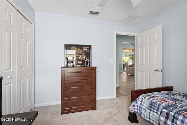 573 N Bridgestone Ave, Saint Johns, FL 32259 - bedroom with a closet, arched walkways, carpet floors, a textured ceiling, and ceiling fan