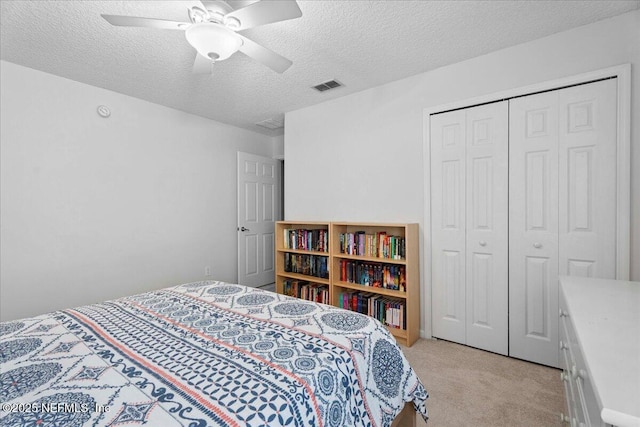 573 N Bridgestone Ave, Saint Johns, FL 32259 - bedroom featuring light colored carpet, a textured ceiling, a closet, and a ceiling fan