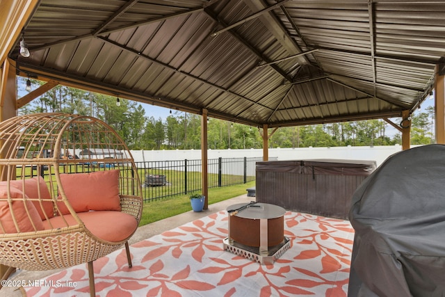 36501 Shortleaf Ave, Hilliard, FL 32046 - fenced backyard featuring a hot tub, a patio, a gazebo, and a grill