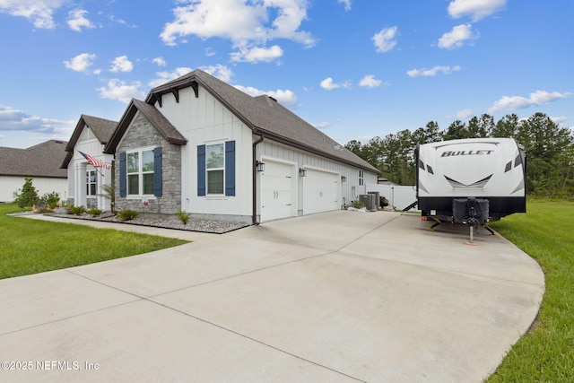 36501 Shortleaf Ave, Hilliard, FL 32046 - view of side of property with board and batten siding, a yard, concrete driveway, stone siding, and roof with shingles