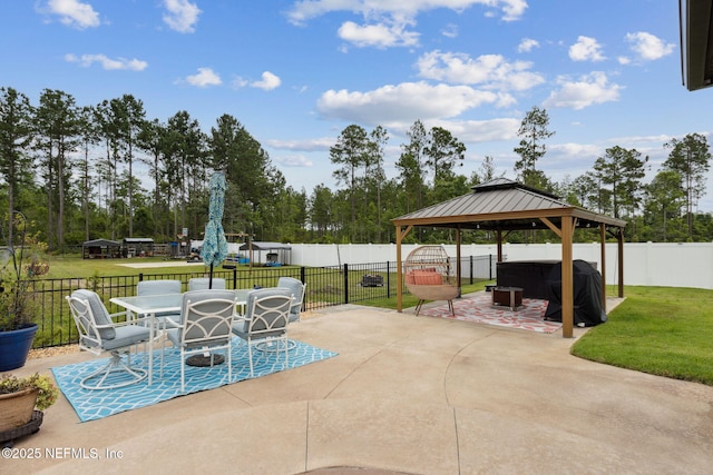 36501 Shortleaf Ave, Hilliard, FL 32046 - fenced backyard featuring a patio area, a gazebo, outdoor dining area, area for grilling, and view of scattered trees