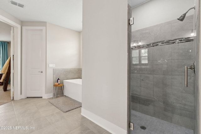36501 Shortleaf Ave, Hilliard, FL 32046 - bathroom with a freestanding bath, a shower stall, and tile patterned floors