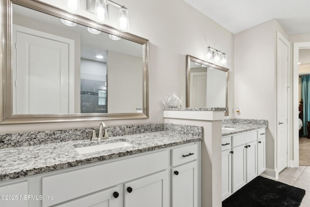 36501 Shortleaf Ave, Hilliard, FL 32046 - bathroom featuring two vanities, tile patterned flooring, and tiled shower