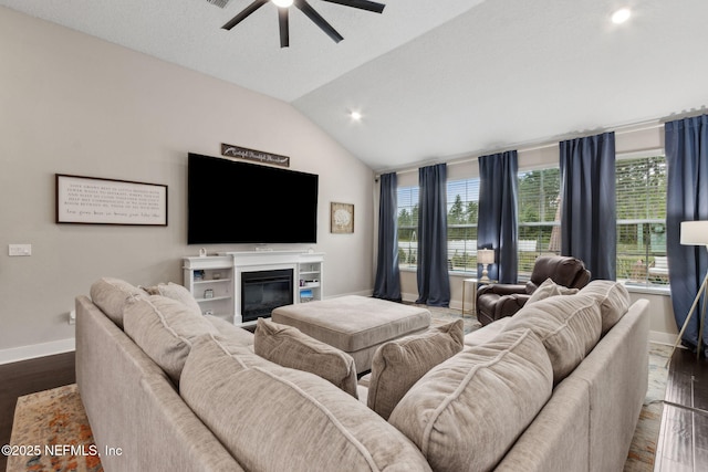 36501 Shortleaf Ave, Hilliard, FL 32046 - living room featuring ceiling fan, vaulted ceiling, wood finished floors, a glass covered fireplace, and recessed lighting