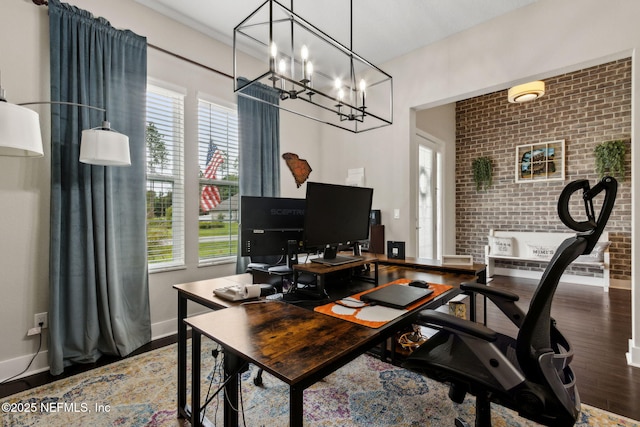 36501 Shortleaf Ave, Hilliard, FL 32046 - home office featuring wood finished floors, a chandelier, healthy amount of natural light, and brick wall