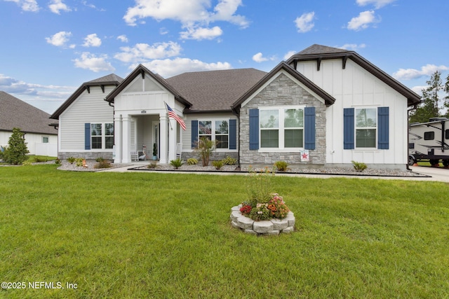 36501 Shortleaf Ave, Hilliard, FL 32046 - view of front of house with stone siding, board and batten siding, a front lawn, and roof with shingles