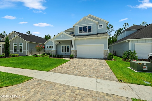 238 Courtney Chase Dr, Saint Augustine, FL 32092 - craftsman inspired home featuring decorative driveway, stone siding, a front lawn, and a garage