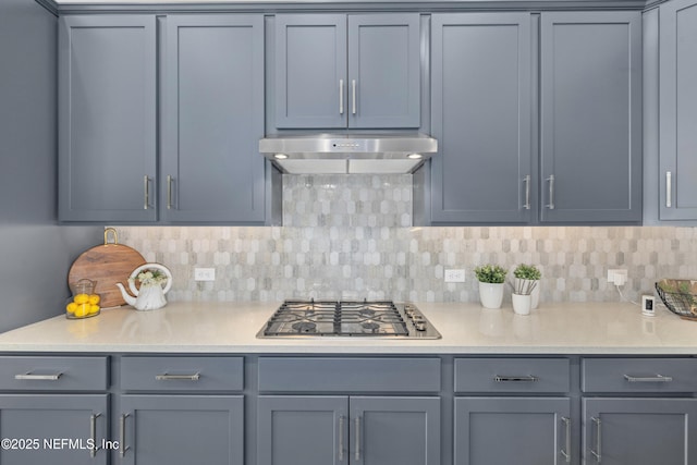 238 Courtney Chase Dr, Saint Augustine, FL 32092 - kitchen featuring under cabinet range hood, stainless steel gas stovetop, gray cabinetry, and tasteful backsplash