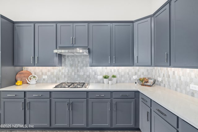 238 Courtney Chase Dr, Saint Augustine, FL 32092 - kitchen featuring stainless steel gas cooktop, under cabinet range hood, tasteful backsplash, gray cabinetry, and light countertops