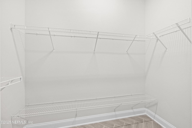 238 Courtney Chase Dr, Saint Augustine, FL 32092 - walk in closet featuring wood finished floors
