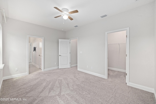 238 Courtney Chase Dr, Saint Augustine, FL 32092 - unfurnished bedroom with a spacious closet, carpet, a closet, ensuite bathroom, and a ceiling fan