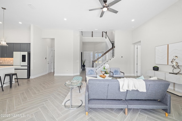 238 Courtney Chase Dr, Saint Augustine, FL 32092 - living area with stairway, ceiling fan, recessed lighting, and a towering ceiling