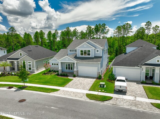 238 Courtney Chase Dr, Saint Augustine, FL 32092 - view of front of home with decorative driveway, stone siding, and a front lawn