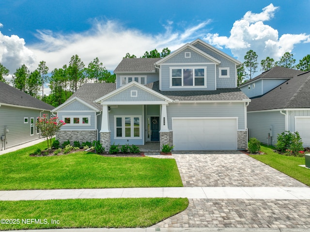 238 Courtney Chase Dr, Saint Augustine, FL 32092 - craftsman-style home featuring stone siding, decorative driveway, a front lawn, and a garage