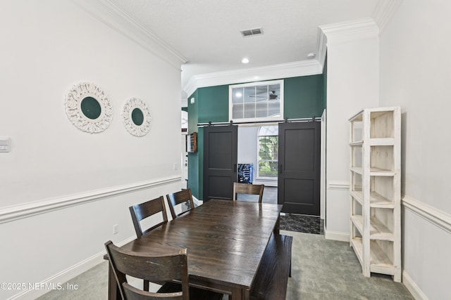 1288 Creek Bend Rd, Saint Johns, FL 32259 - dining space featuring ornamental molding, carpet floors, a barn door, and a decorative wall