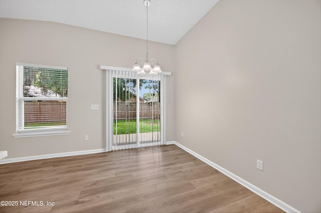 1359 Cove Landing Dr, Jacksonville, FL 32233 - unfurnished dining area featuring a chandelier, light wood-style floors, and high vaulted ceiling