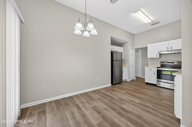 1359 Cove Landing Dr, Jacksonville, FL 32233 - kitchen featuring appliances with stainless steel finishes, under cabinet range hood, light countertops, light wood finished floors, and white cabinetry