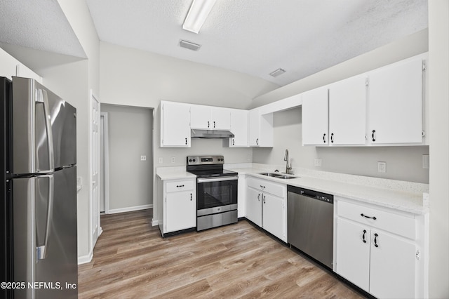 1359 Cove Landing Dr, Jacksonville, FL 32233 - kitchen with appliances with stainless steel finishes, white cabinets, light wood-style floors, light countertops, and a textured ceiling