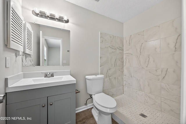1359 Cove Landing Dr, Jacksonville, FL 32233 - bathroom with vanity, a tile shower, a textured ceiling, and wood finished floors