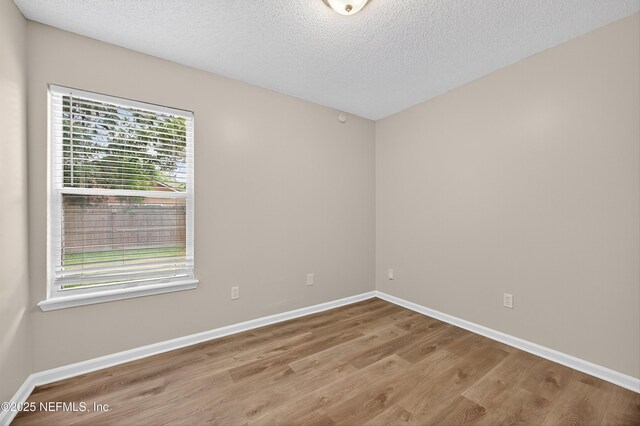1359 Cove Landing Dr, Jacksonville, FL 32233 - spare room with wood finished floors and a textured ceiling