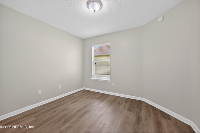 1359 Cove Landing Dr, Jacksonville, FL 32233 - spare room featuring wood finished floors, a textured ceiling, and a smoke detector
