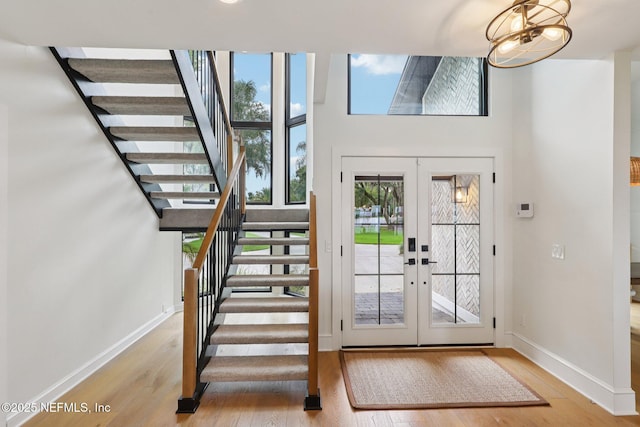 1823 N Lakeshore Dr, Fleming Island, FL 32003 - foyer entrance featuring wood finished floors, stairs, french doors, and a towering ceiling