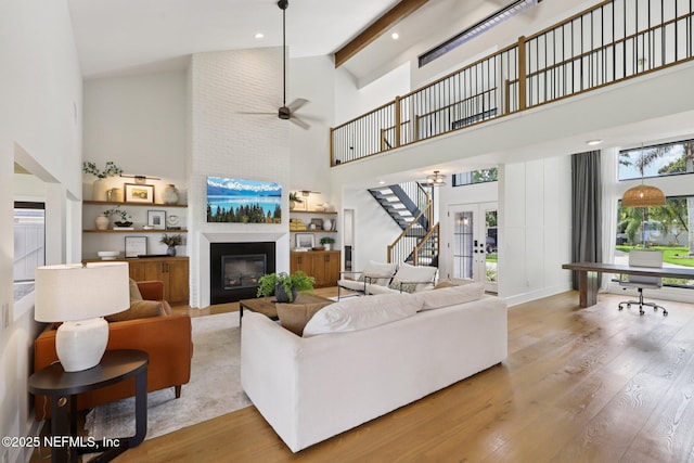 1823 N Lakeshore Dr, Fleming Island, FL 32003 - living room featuring high vaulted ceiling, light wood finished floors, a large fireplace, ceiling fan, and beamed ceiling