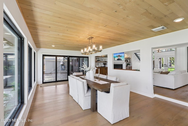 1823 N Lakeshore Dr, Fleming Island, FL 32003 - unfurnished dining area with french doors, wood ceiling, light wood-style flooring, and a chandelier
